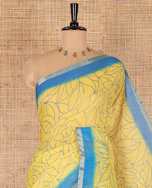 Yellow rose floral printed linen cotton saree, contrast piping border, rose floral printed pallu, and a contrast leaf motifs printed blouse