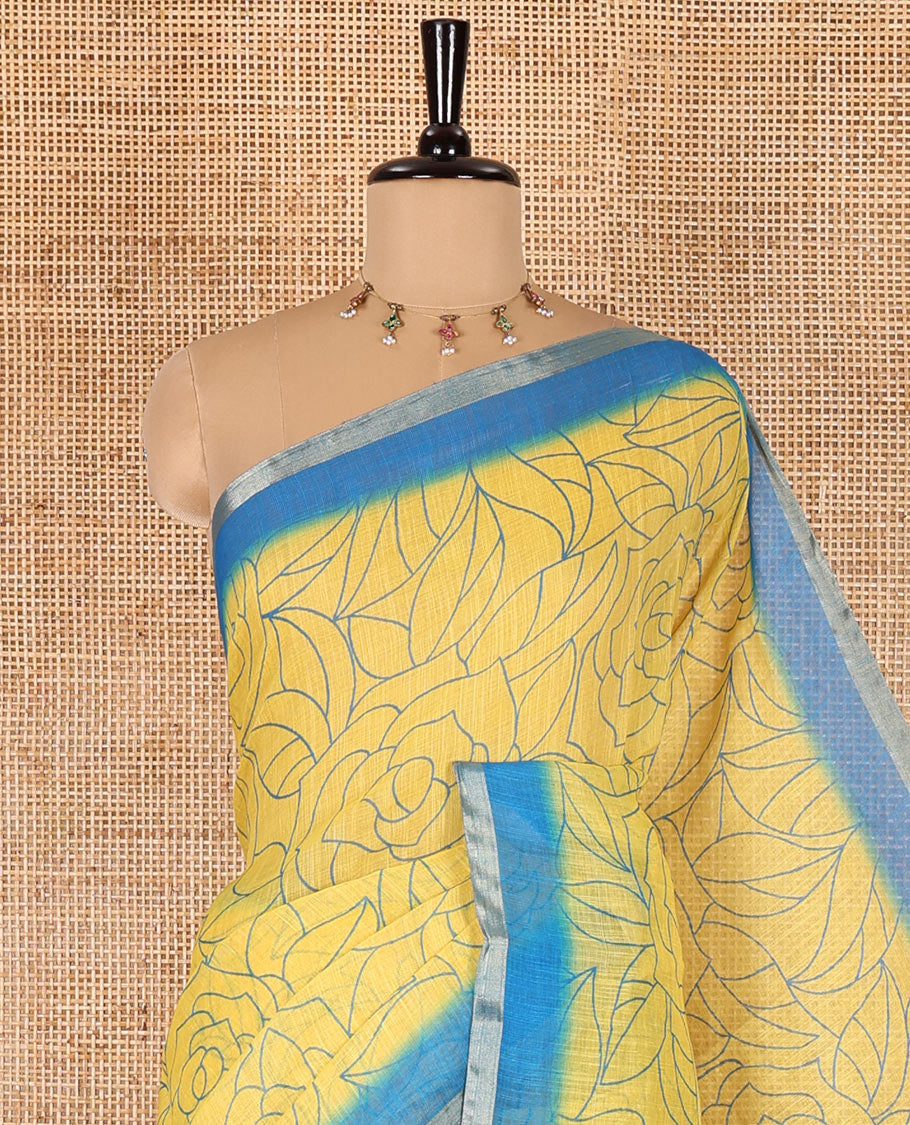 Yellow rose floral printed linen cotton saree, contrast piping border, rose floral printed pallu, and a contrast leaf motifs printed blouse