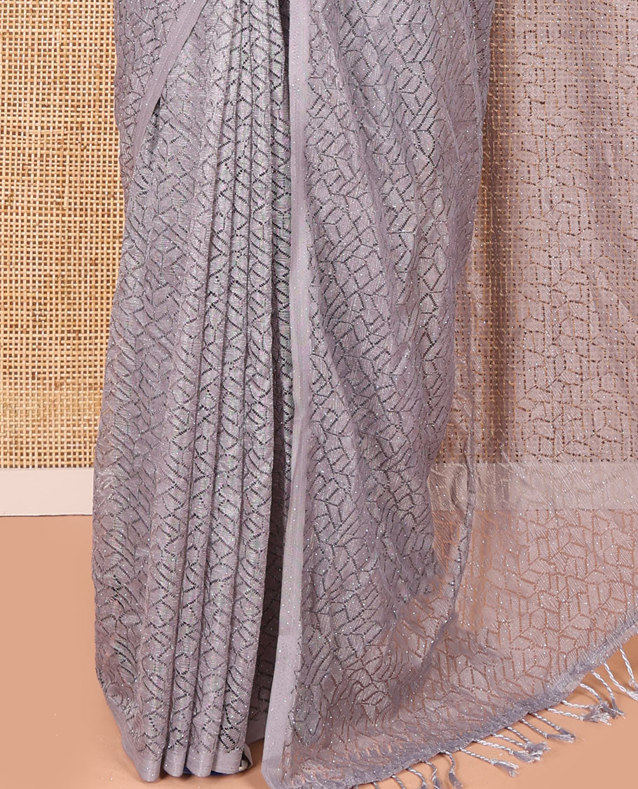 Borderless grey sparkling glittered russel net saree, self-pallu and a floral print with zig-zag embroidered blouse