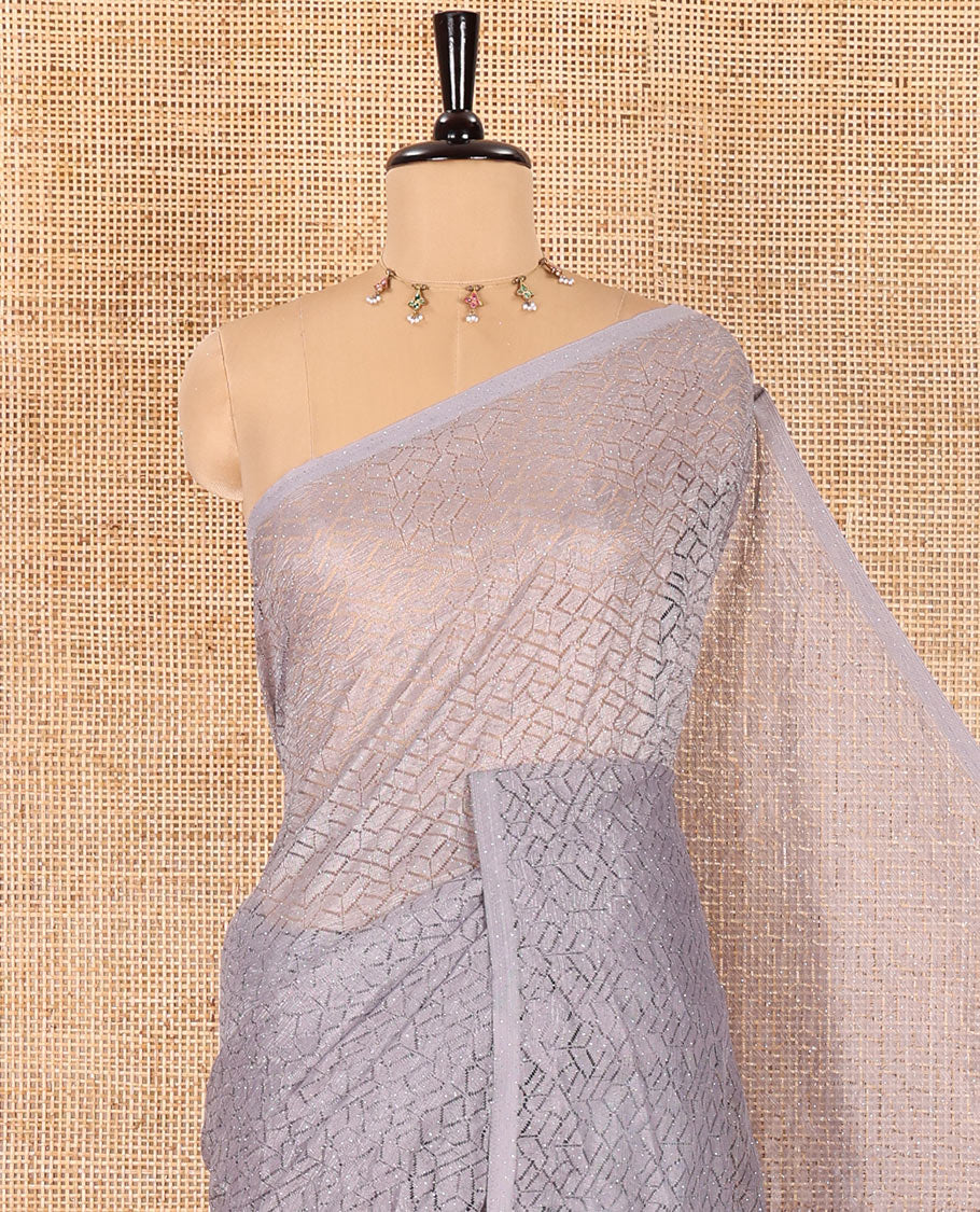 Borderless grey sparkling glittered russel net saree, self-pallu and a floral print with zig-zag embroidered blouse