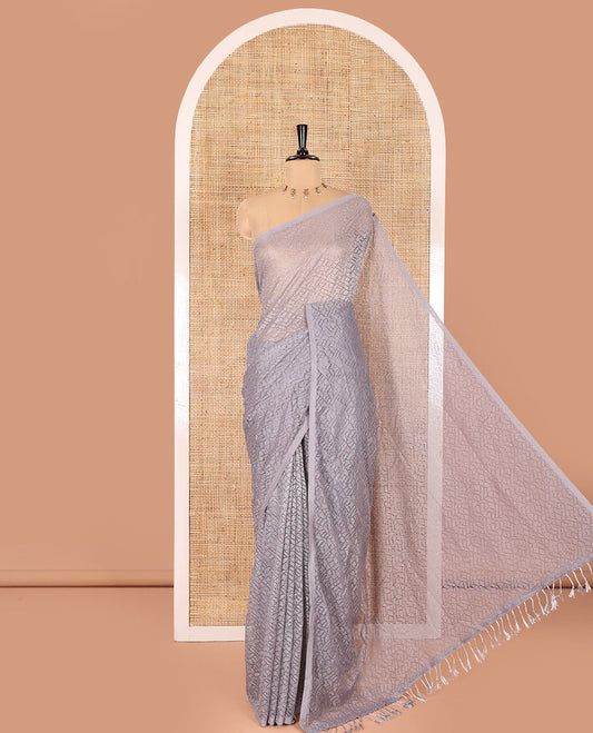Borderless grey sparkling glittered russel net saree, self-pallu and a floral print with zig-zag embroidered blouse
