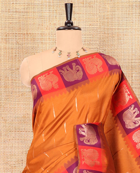 Rust orange copper zari buttas woven kanchi silk saree, contrast temple border of peacock and elephant motifs, zari-rich pallu, and a zari design blouse