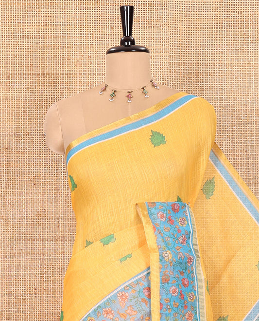 Yellow Linen Saree Detailed with Leaf Motifs All Over Its Body, Complemented by a Contrast Floral Vine Printed Border, Pallu Mirrors the Floral Vine Print, and Paired with a  Contrast Floral Printed Blouse