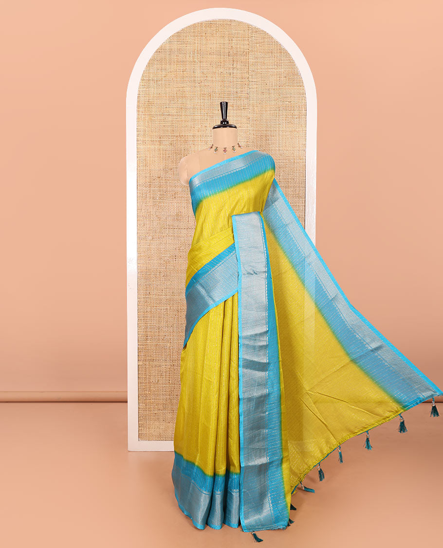 Green Dola Silk Saree Subtly Sparked with Vertical Golden Stripes Running All Over Its Body, Complemented by a Contrast Traditional Zari Design Woven Border, Subtly Striped Pallu, and a Contrast Buttas Woven Blouse