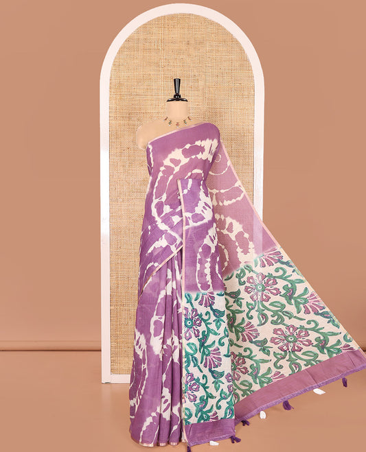 Borderless Purple Linen Cotton Saree Adorned with Shibori Prints, Complemented by Contrast Pallu Steeped with Floral Vine Print, and Paired with a Contrast Floral Printed Blouse