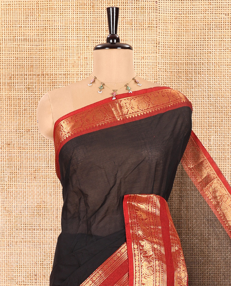 Black Plain Chettinad Cotton Saree Elevated with a Contrasting Temple Rettai Pettu Border of Peacock-Elephant Motifs, a Subtle Pallu of Stripes, and a Matching Blouse