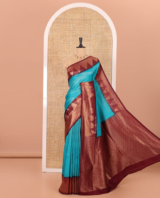 Blue Luxury Soft Silk Saree Accentuated with 1000 Zari Buttas All Over Its Body, Complemented by a Contrast Temple Zari Border, Grandly Woven Pallu of Jaal Designs, and Paired with a Contrast Jacquard Blouse