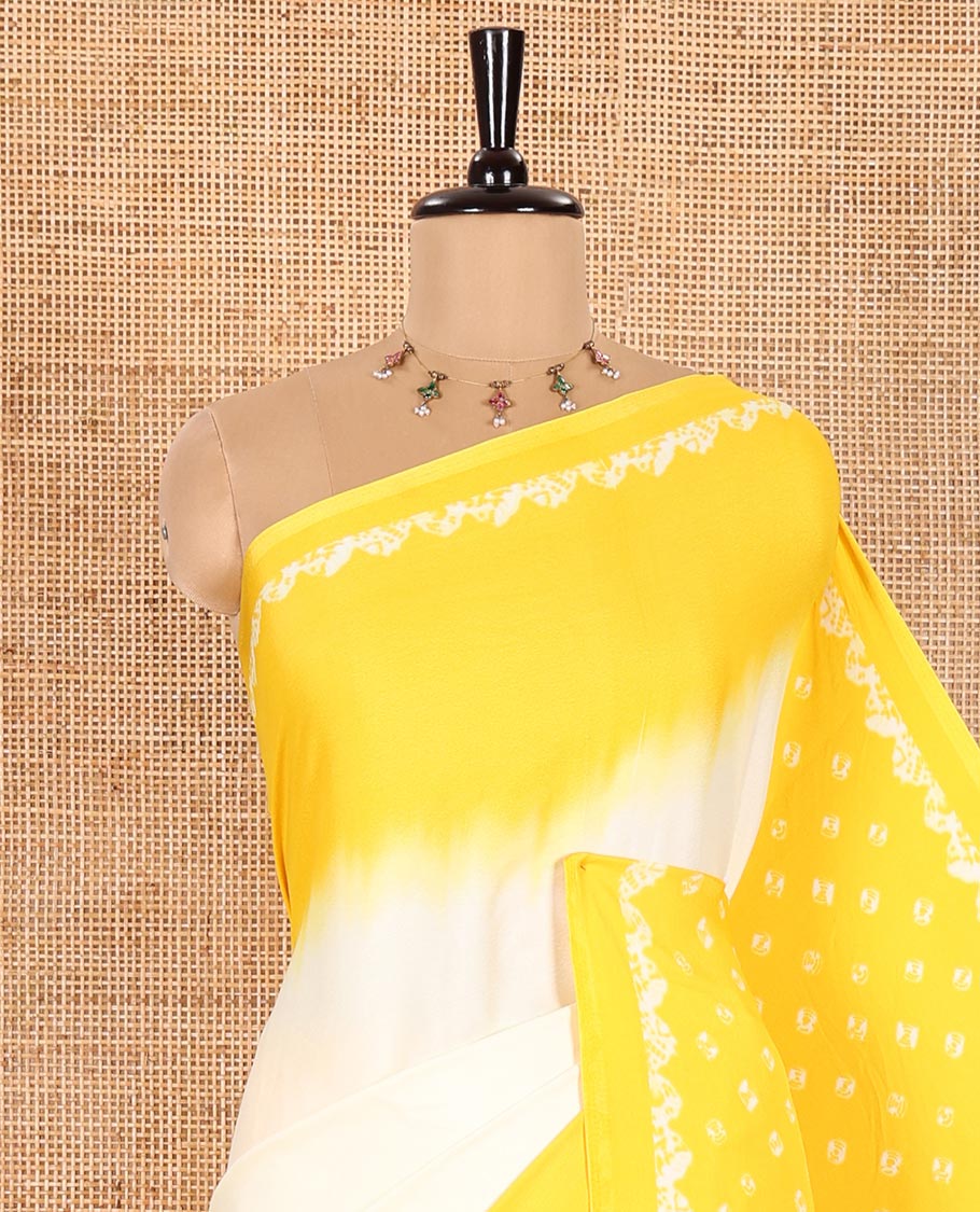 Cream and Yellow Satin Crepe Saree Embellished with Shibori Prints, Complemented by Contrast Shibori Printed Border, Pallu Decked Up with Shibori Prints, and Paired with a Plain Blouse
