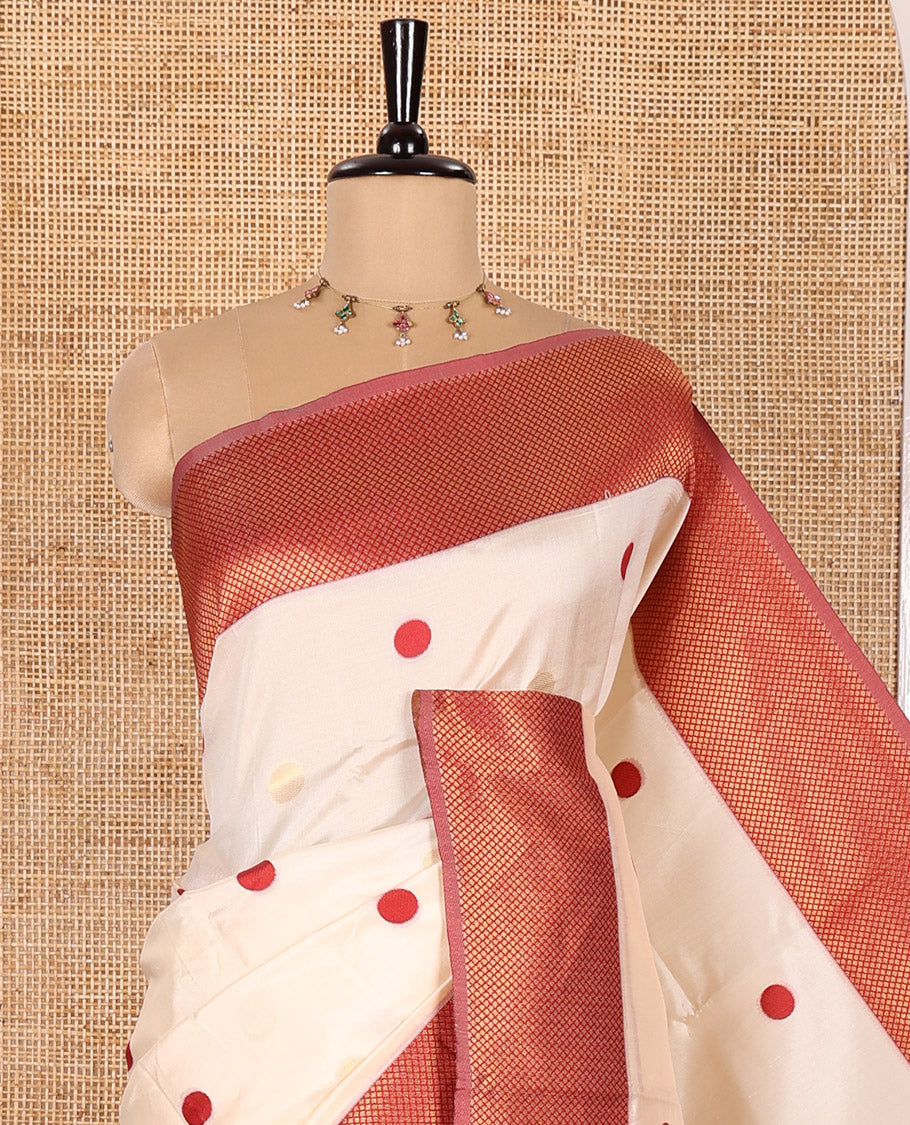 Cream and Red Semi-Soft Silk Saree Embellished with Polka Dot Buttas All Over Its Body, Complemented by a Contrast Jaal Design Border, Pallu of Geometric Patterns, and Paired with a Contrast Blouse