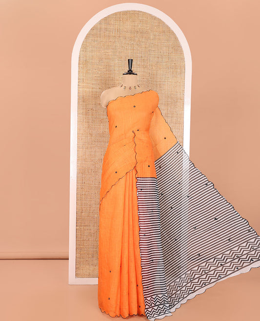 Orange Linen Cotton Saree, Subtly Sparkled with Mirror Work All Over Its Body, Subtly Scallop Border, Complemented by Contrast Pallu of Stripes and Mirror Work, and Paired with a Contrast Geometric Printed Blouse