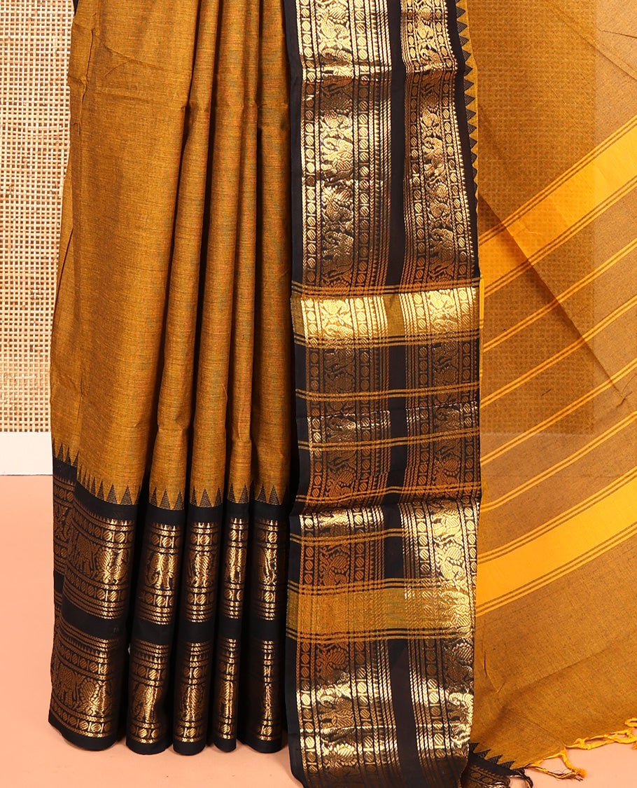 Mustard Plain Chettinad Cotton Saree, Complemented by a Contrast Rettai Pettu Temple Bright Gold Zari Border of Coin, Elephant, and Peacock Designs, Subtly Striped Pallu, and Paired with a Matching Blouse