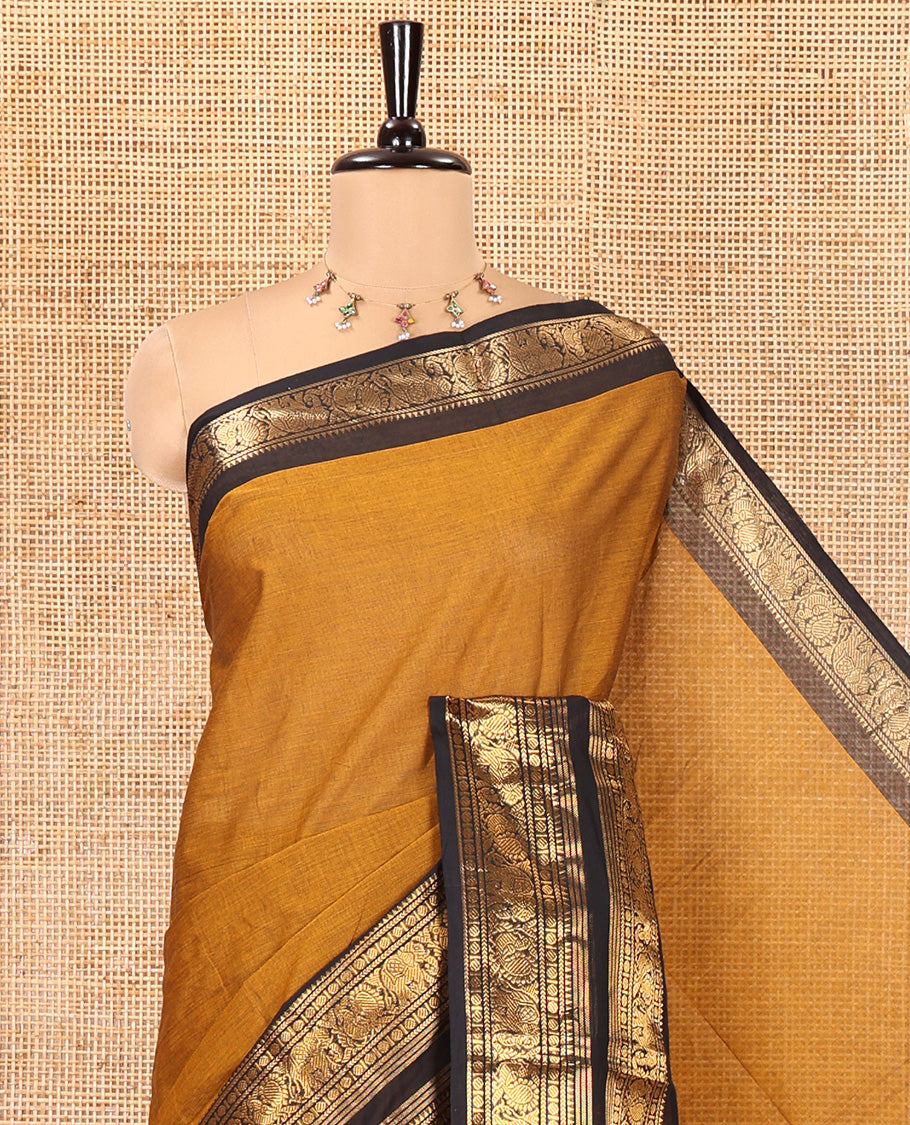 Mustard Plain Chettinad Cotton Saree, Complemented by a Contrast Rettai Pettu Zari Border of Thread-Temple, Coin, Elephant, and Peacock Designs, Subtly Striped Pallu, and Paired with a Matching Blouse