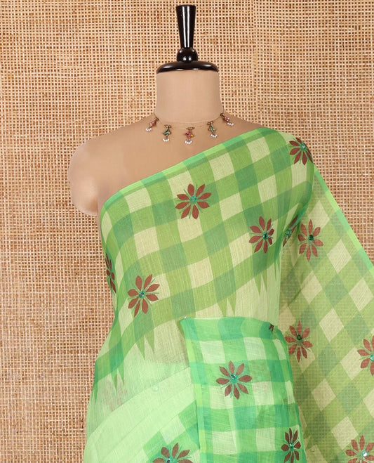 Green Linen Cotton Saree, Gleamed up with Mirror Work On Its Body, Complemented by Contrast Temple Checked Border of Floral Print and Mirror Work, Pallu Mirrors the Same Design and Paired with a Contrast Blouse