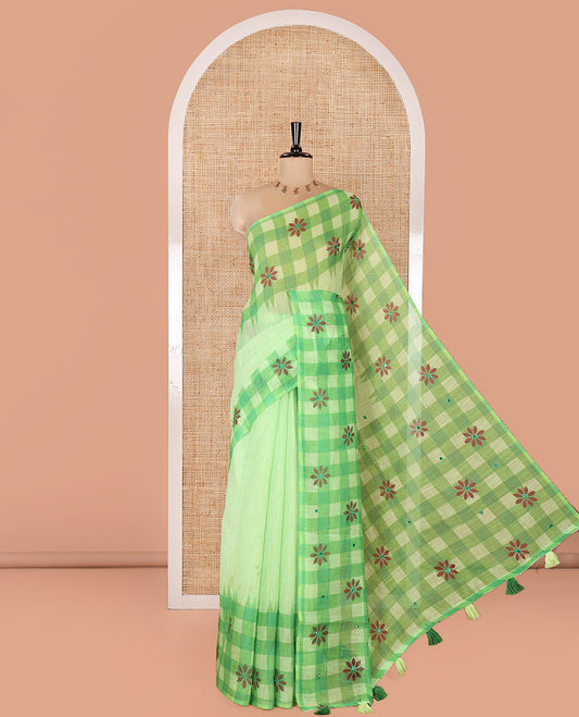 Green Linen Cotton Saree, Gleamed up with Mirror Work On Its Body, Complemented by Contrast Temple Checked Border of Floral Print and Mirror Work, Pallu Mirrors the Same Design and Paired with a Contrast Blouse