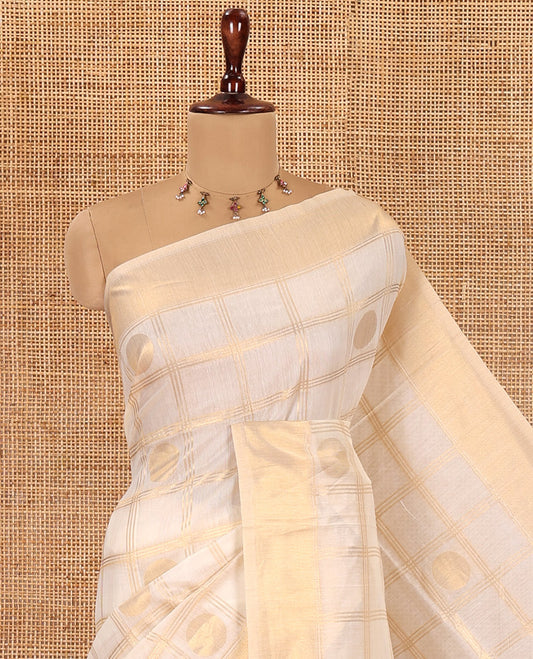 Cream Chanderi Cotton Saree Features Polka Dot Enclosed Checks, a Zari Border, a Matching Blouse