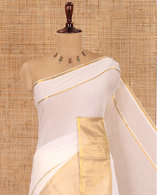Cream Plain Khadi Mul Cotton Saree, Golden Zari Border, a Self-Pallu with Tassels, and No Blouse