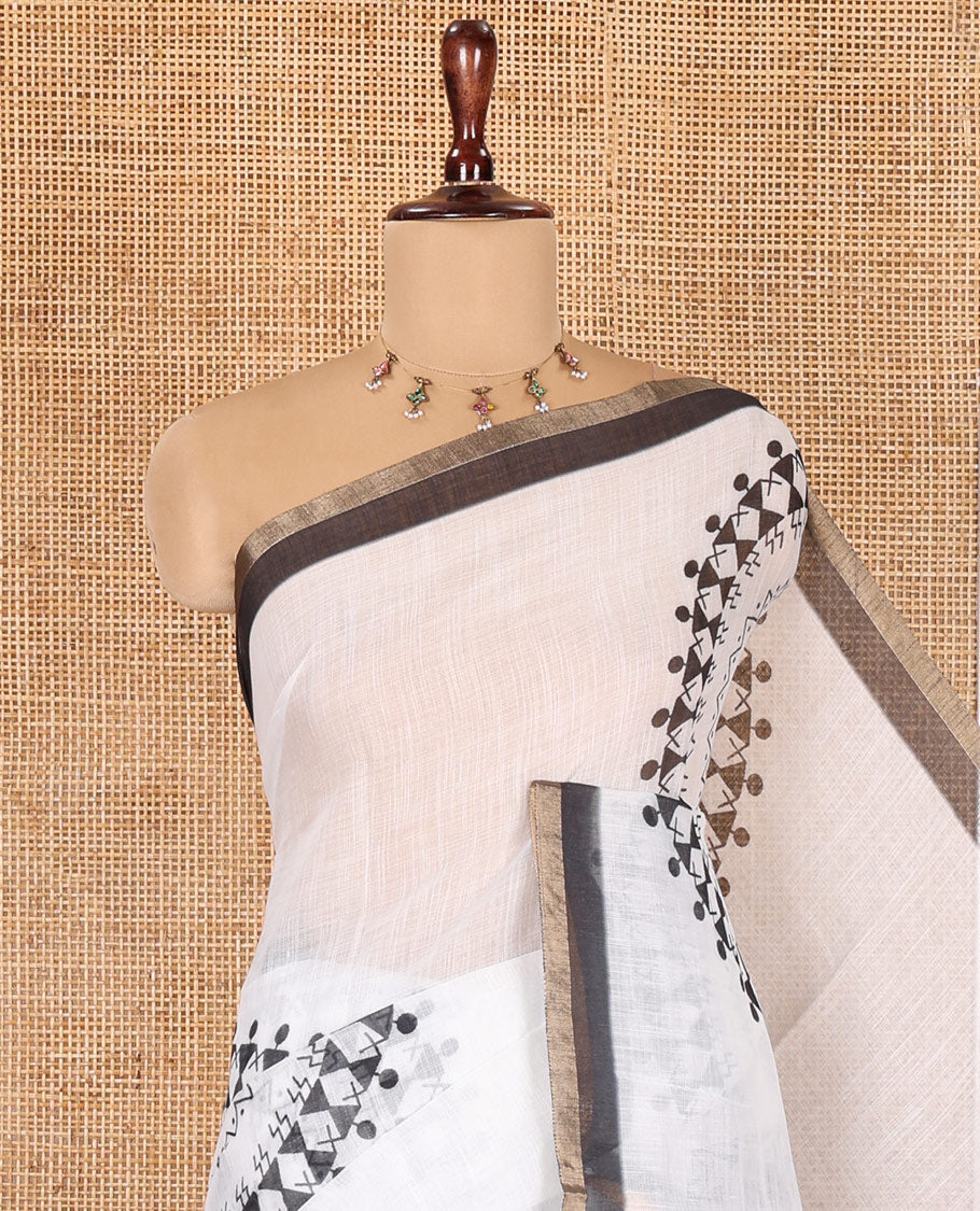 White Linen Cotton Saree Features Warli Print, a Contrast Piping Border, a Floral-Printed Pallu, and a Contrast Blouse