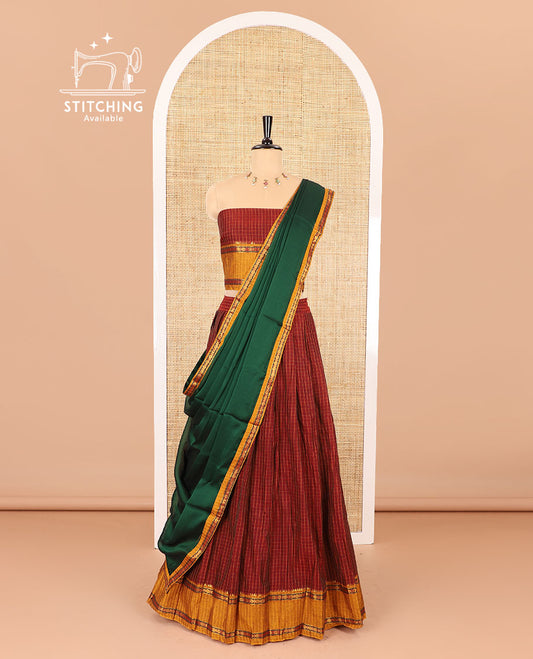 Red half-saree, checked with contrast traditional motifs zari bordered skirt, matching blouse and a contrast zari border plain dhavani