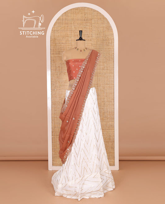 Cream-rust half-saree, gold chevron striped nylon viscose crepe skirt, contrast diamond buttas blouse, and  a contrast scallop floral-theme embroidered dhavani