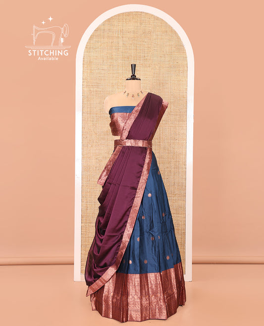 Blue and Purple Semi-Banarasi Half-Saree, Accentuated with Zari Buttas on Its Skirt, Complemented by a Contrast Traditional Zari-Design Border, Paired with a Matching Blouse, and a Contrast Satin Georgette Zari-Bordered Dhavani