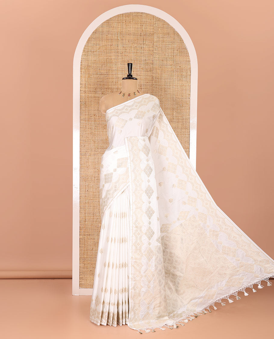 Borderless white zari buttas and diamond buttas mushru silk saree, intricately designed pallu, and a matching blouse