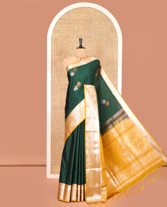 Bottle Green Semi-Soft Silk Saree, Detailed with Zari Buttas All Over Its Body, Complemented by a Contrast Traditional Zari Design Border, Intricately Designed Pallu, and Paired with a Contrast Blouse