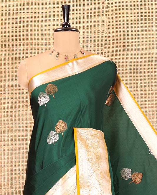 Bottle Green Semi-Soft Silk Saree, Detailed with Zari Buttas All Over Its Body, Complemented by a Contrast Traditional Zari Design Border, Intricately Designed Pallu, and Paired with a Contrast Blouse
