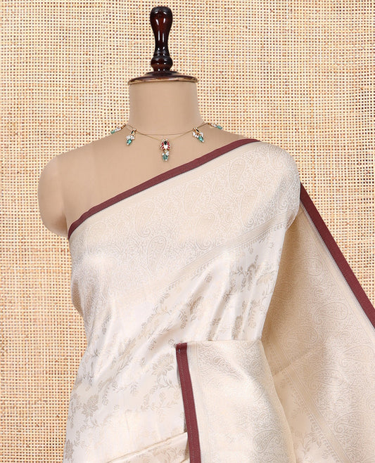 Off-White-Brown Semi-Silk Saree, Adorned with Floral Jacquard Design, a Zari Paisley Border, and a Contrast Blouse