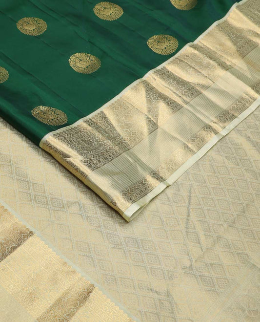 Green round buttas Vasundhara silk mix saree, contrast border of thilakam, muthu, diamond, neli, mayil, and zari designs, and jaal pallu