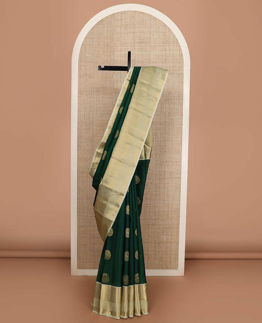 Green round buttas Vasundhara silk mix saree, contrast border of thilakam, muthu, diamond, neli, mayil, and zari designs, and jaal pallu