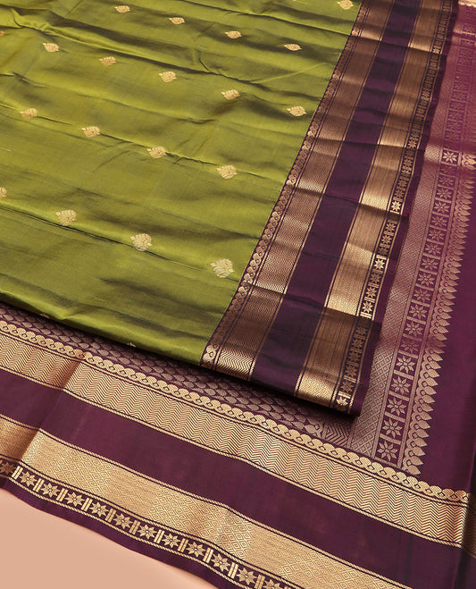 Green Vasundhara Lite Silk Mix Saree, Enthralled with Zari Buttas, Complemented by a Contrast Rettai Pettu Border of Salngai, Banaras, Vanki, Mayil Kann, and Star Vanki Designs, Pallu Steeped with Thilakam Designs, and Paired with a Contrast Blouse