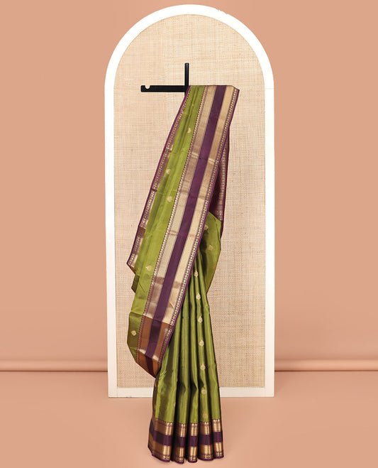 Green Vasundhara Lite Silk Mix Saree, Enthralled with Zari Buttas, Complemented by a Contrast Rettai Pettu Border of Salngai, Banaras, Vanki, Mayil Kann, and Star Vanki Designs, Pallu Steeped with Thilakam Designs, and Paired with a Contrast Blouse