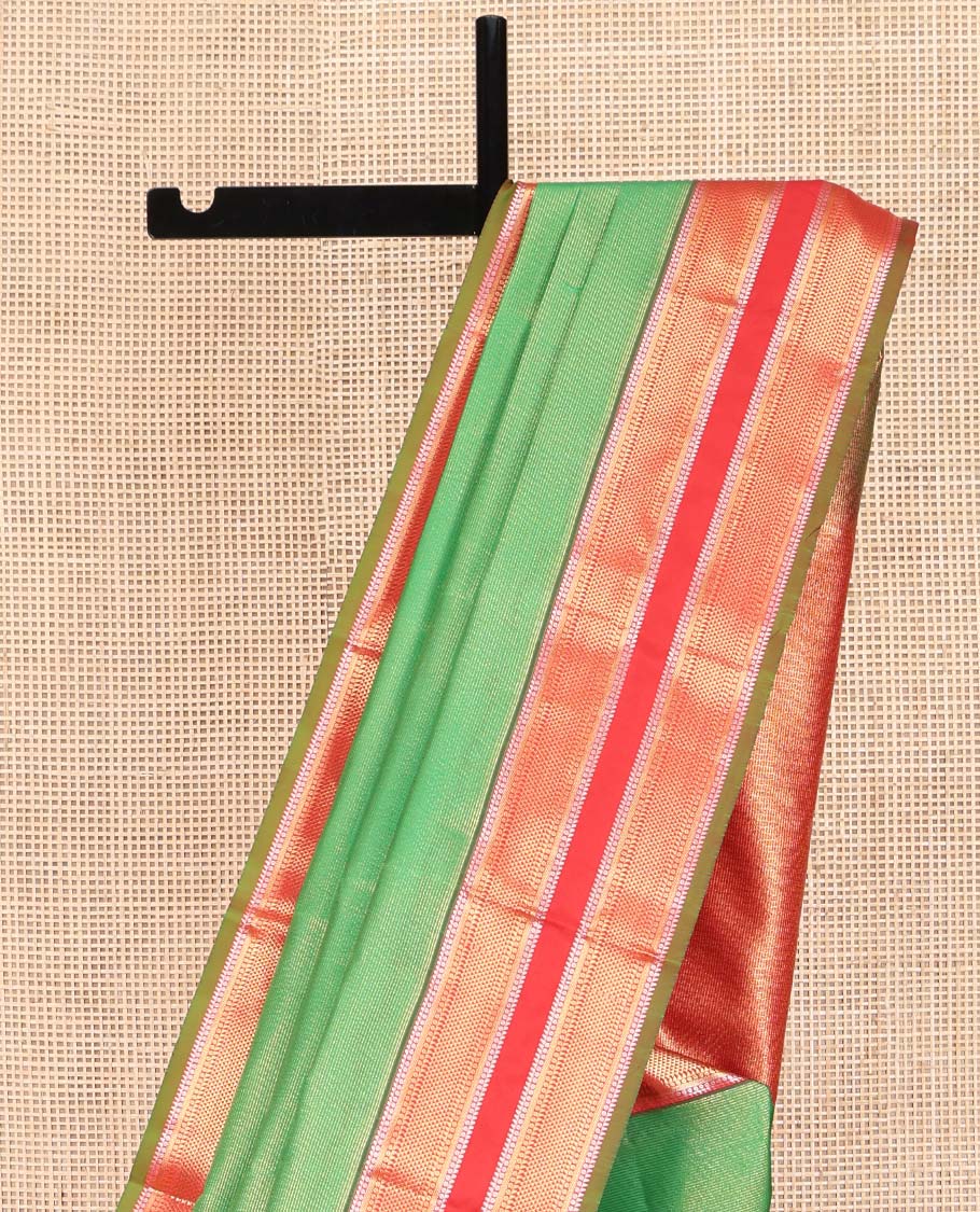 Green Vasundhara Lite Silk Mix Saree, Delicately Woven with Zari Stripes on Its Body, Complemented by a Contrast Rettai Pettu Border of Ara Bogudi, Paisa, Banaras, and Ara Maadam Designs, a Grand Pallu, and Paired with a Contrast Blouse