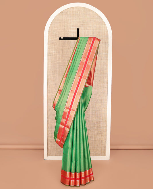 Green Vasundhara Lite Silk Mix Saree, Delicately Woven with Zari Stripes on Its Body, Complemented by a Contrast Rettai Pettu Border of Ara Bogudi, Paisa, Banaras, and Ara Maadam Designs, a Grand Pallu, and Paired with a Contrast Blouse