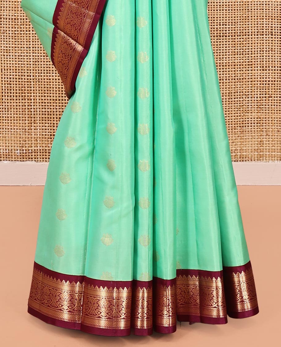 Light Turquoise Vasundhara Silk Saree, Sparsely Woven with Zari Buttas All Over Its Body, Complemented by a Contrast Border of Rekku, Muthu, Kathir, and Kodi Visiry Designs, Grand Jaal Pallu, and Paired with a Contrast Blouse
