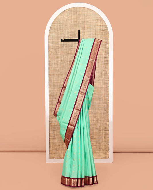 Light Turquoise Vasundhara Silk Saree, Sparsely Woven with Zari Buttas All Over Its Body, Complemented by a Contrast Border of Rekku, Muthu, Kathir, and Kodi Visiry Designs, Grand Jaal Pallu, and Paired with a Contrast Blouse
