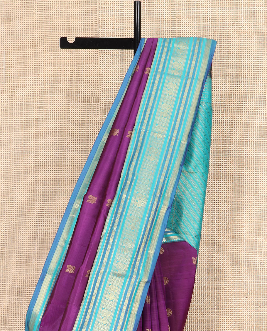 Purple Vasundhara Silk Saree Detailed with Mayil Chakram Buttas, Complemented by a Contrast Varisai Pettu Border of Rekku, Muthu, Kathir, Rudraksham, Mayil, and Mayil Kann Designs, Gleaming Pallu of Diagonal Stripes, and Paired with a Contrast Blouse
