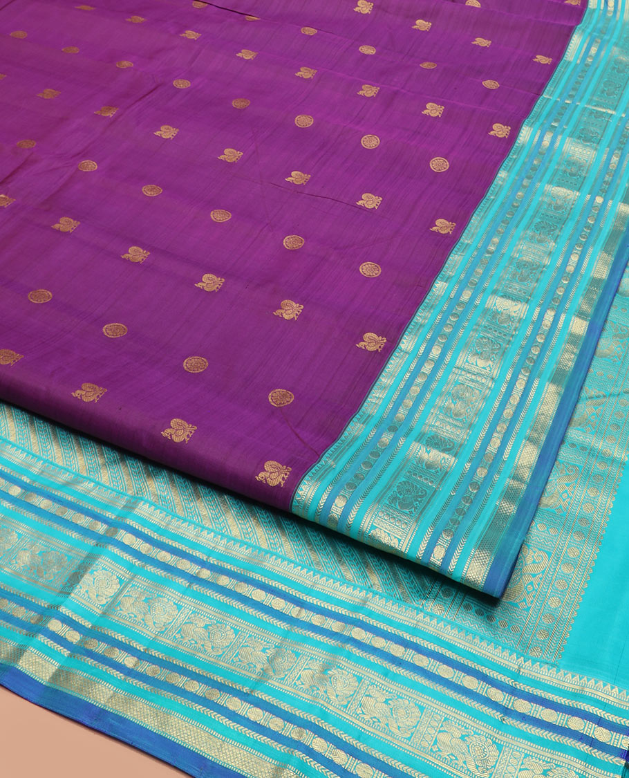 Purple Vasundhara Silk Saree Detailed with Mayil Chakram Buttas, Complemented by a Contrast Varisai Pettu Border of Rekku, Muthu, Kathir, Rudraksham, Mayil, and Mayil Kann Designs, Gleaming Pallu of Diagonal Stripes, and Paired with a Contrast Blouse