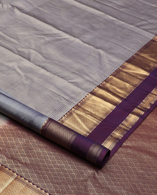 Grey micro-checked silk saree, contrast rettai pettu border of thazampoo rekku, banaras, muthu, and geometric designs, and jaal pallu