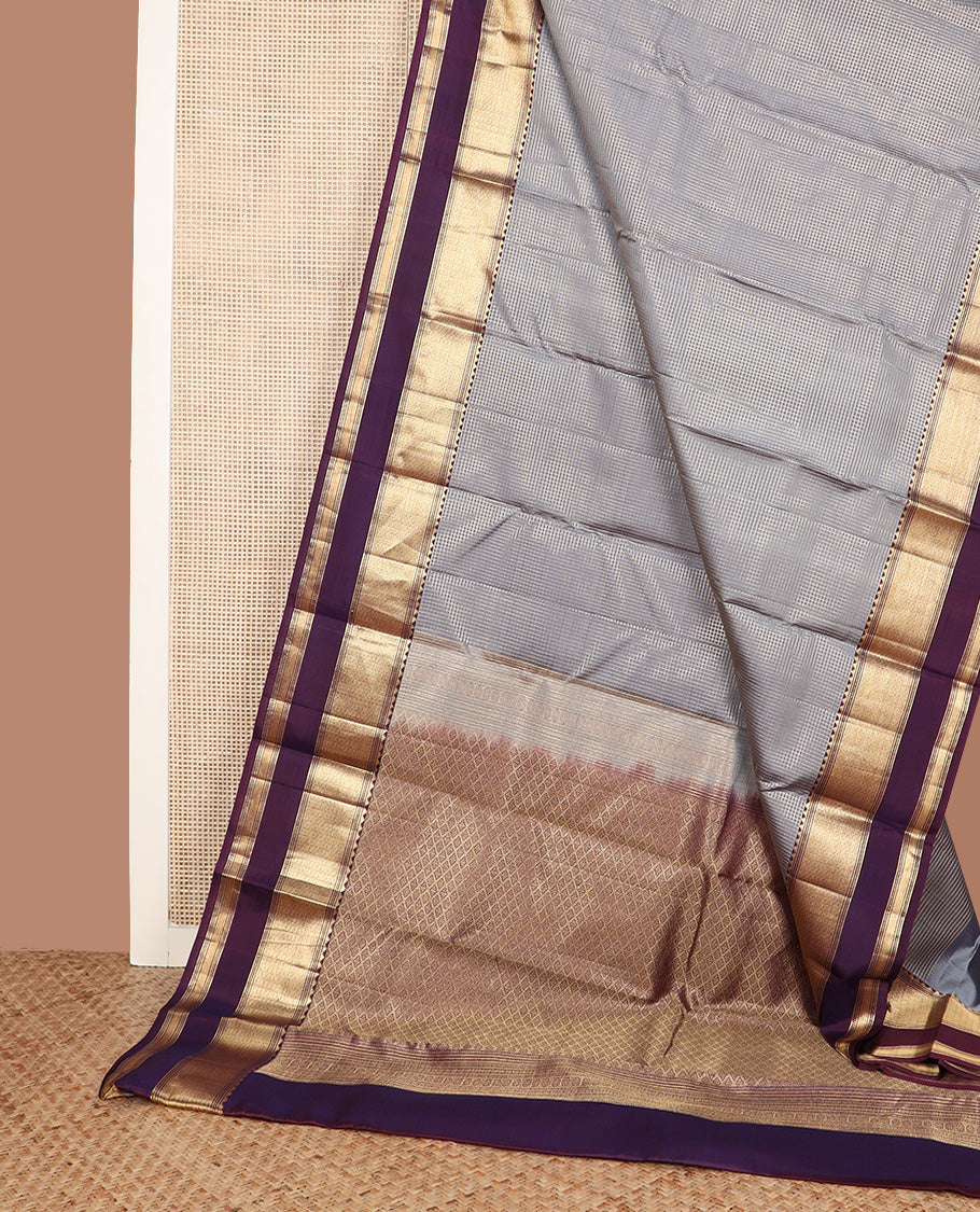 Grey micro-checked silk saree, contrast rettai pettu border of thazampoo rekku, banaras, muthu, and geometric designs, and jaal pallu