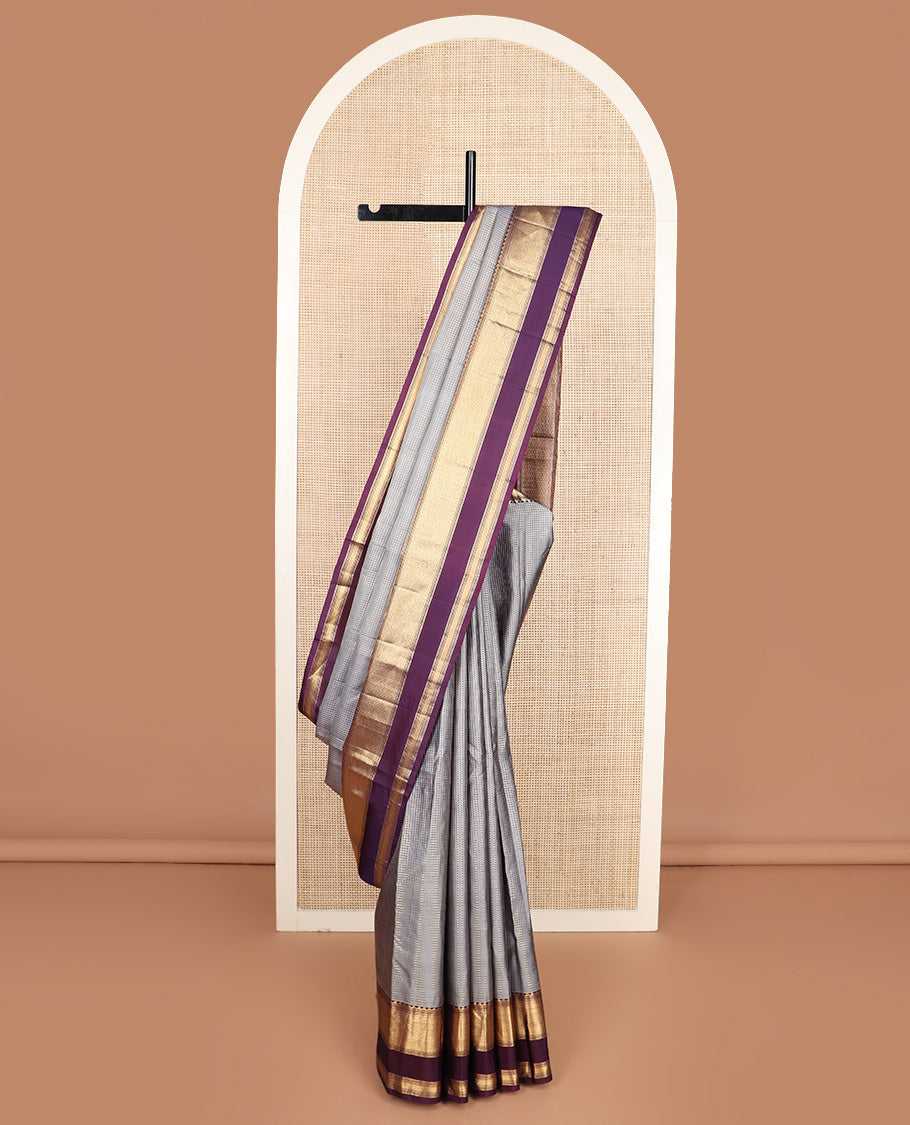 Grey micro-checked silk saree, contrast rettai pettu border of thazampoo rekku, banaras, muthu, and geometric designs, and jaal pallu