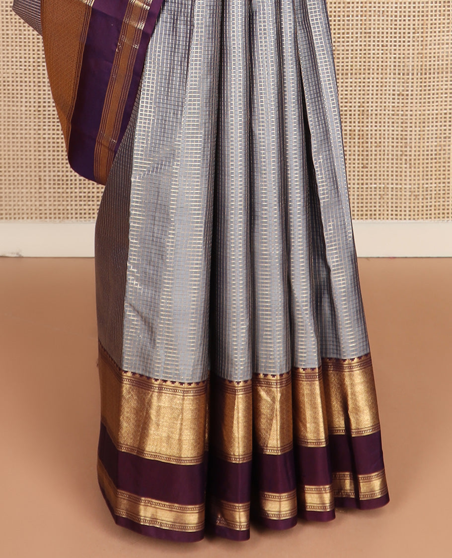 Grey micro-checked silk saree, contrast rettai pettu border of thazampoo rekku, banaras, muthu, and geometric designs, and jaal pallu