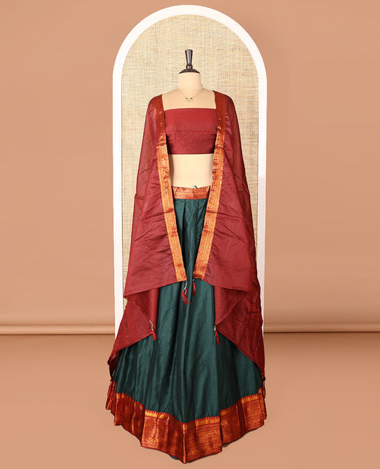 Dark green art-silk half-saree, plain with contrast temple traditional design bordered skirt, contrast blouse, and plain zari bordered dhavani