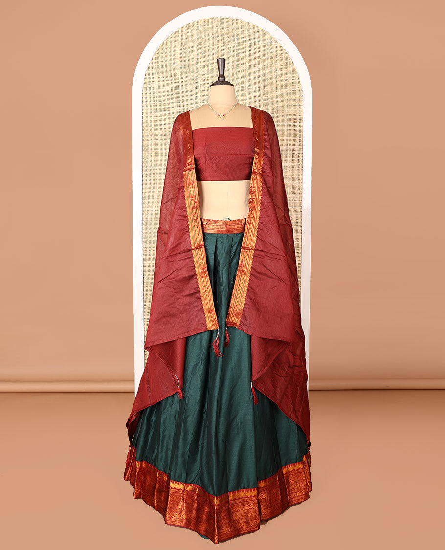 Dark green art-silk half-saree, plain with contrast temple traditional design bordered skirt, contrast blouse, and plain zari bordered dhavani