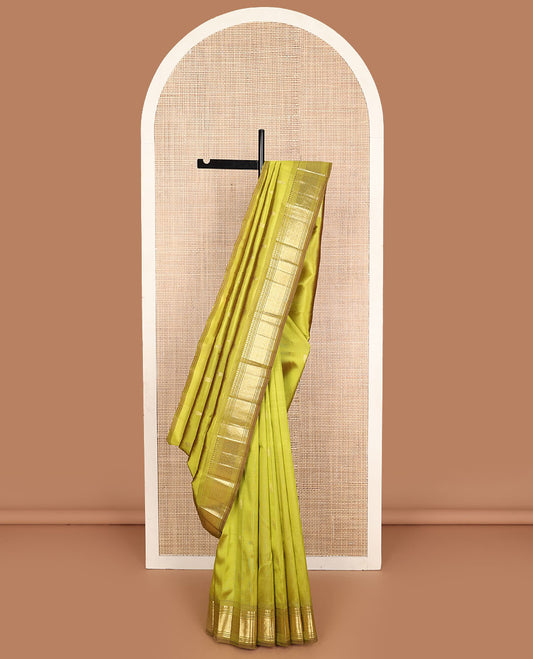 Green zari buttas Kanchipuram silk saree, one-sided zari border of paneer sombu, banaras, muthu, and jaal designs, and zari design pallu