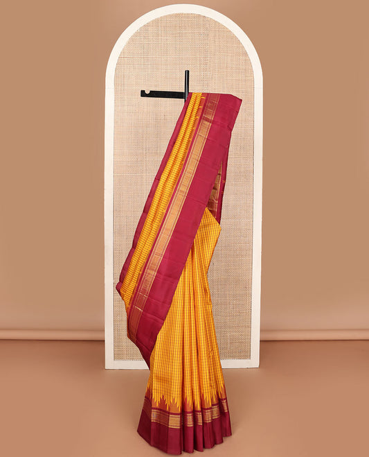 Yellow micro-checked kanchipuram silk saree, contrast thazampoo rekku striped border & pallu of stripes & pillaiyar mokku designs