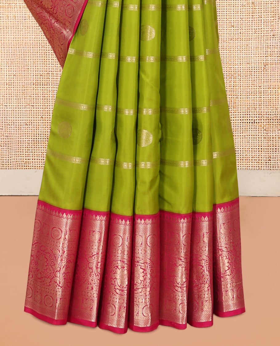 Parrot Green Vasundhara Silk Saree Featuring Veldhari and Round Kuthirai Motifs, Complemented by a Contrast Border of Thilakam Mokku, Muthu, Annam Chakram, and Kodi Visiry Designs, Pallu Elevated with Floral Designs, and Paired with a Contrast Blouse
