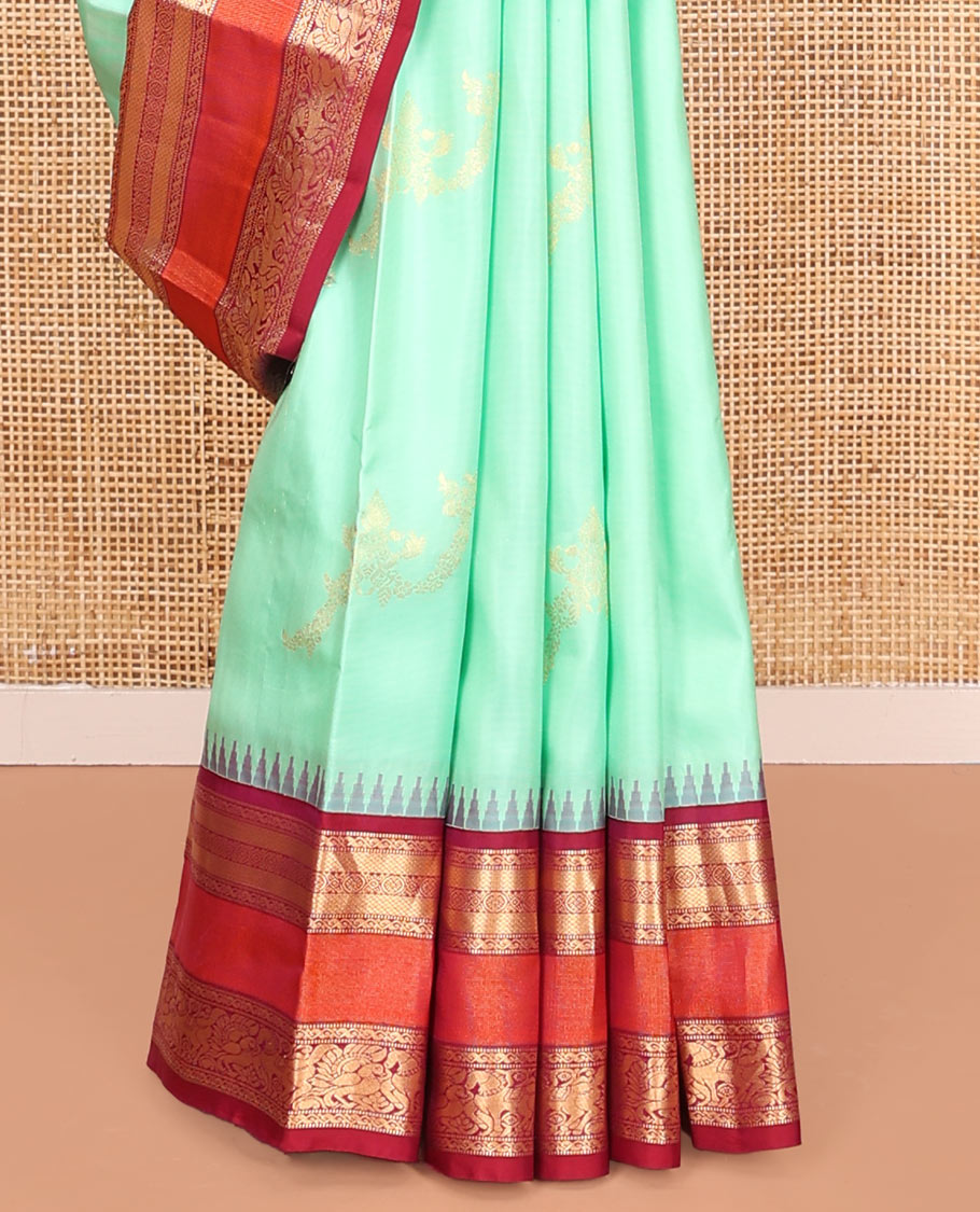 Turquoise Vasundhara Silk Saree, Meticulously Crafted with Zari Buttas on Its Body, Complemented by Contrast Border of Muthu, Mayil Kann, Chakram, Mayil, and Kuthirai Designs, an Intricately Designed Pallu, and Paired with a Contrast Blouse