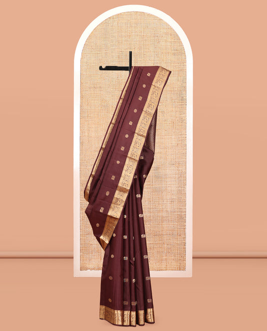 Brown Vasundhara Silk Saree, Enriched with Mayil-Chakram Buttas, a Zari Border of Rekku, Mayil Kann, and Mayil Designs, a Grand Pallu, and a Matching Blouse