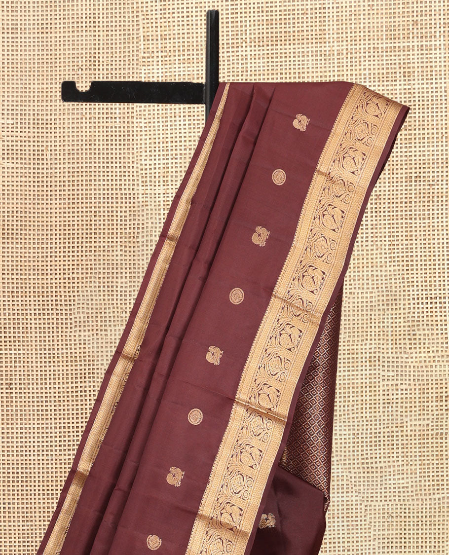 Brown Vasundhara Silk Saree, Enriched with Mayil-Chakram Buttas, a Zari Border of Rekku, Mayil Kann, and Mayil Designs, a Grand Pallu, and a Matching Blouse